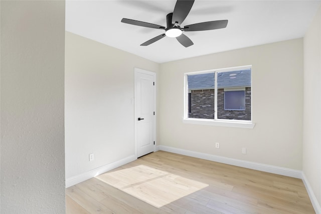 empty room with ceiling fan and light hardwood / wood-style flooring