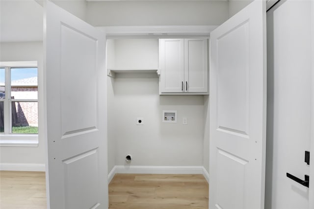 washroom featuring washer hookup, a wealth of natural light, cabinets, and hookup for an electric dryer