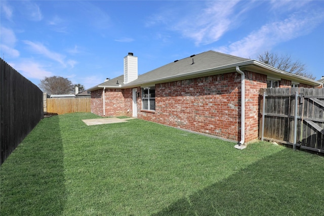 rear view of house featuring a patio and a lawn