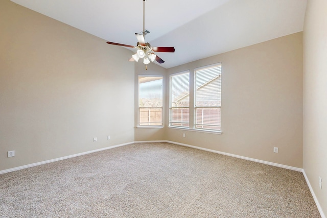 empty room featuring ceiling fan, vaulted ceiling, and carpet