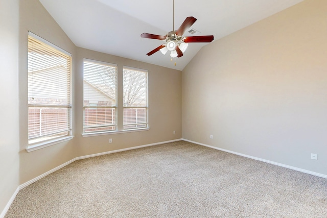 spare room featuring carpet floors, vaulted ceiling, and ceiling fan