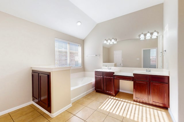 bathroom with tile patterned flooring, vanity, lofted ceiling, and a tub to relax in