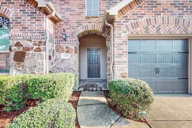 doorway to property with a garage