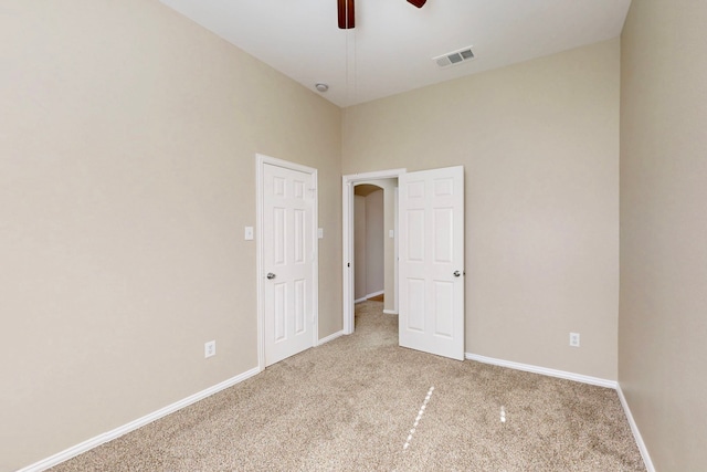 unfurnished bedroom featuring ceiling fan and light colored carpet