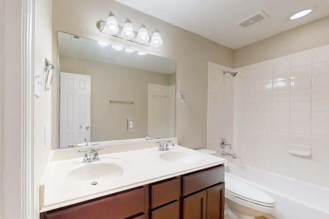 full bathroom with vanity, toilet, and tiled shower / bath combo