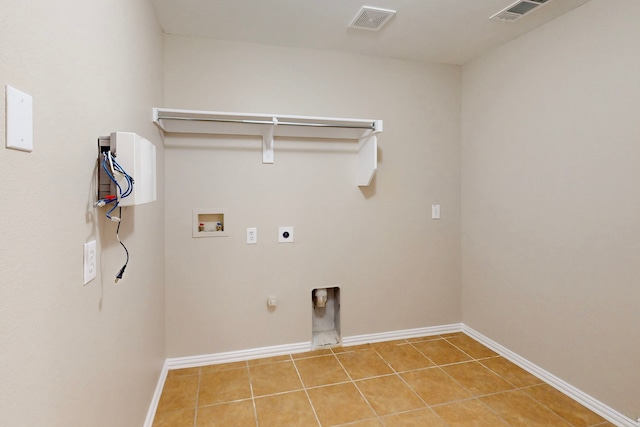 laundry area featuring tile patterned flooring, hookup for a washing machine, hookup for an electric dryer, and gas dryer hookup