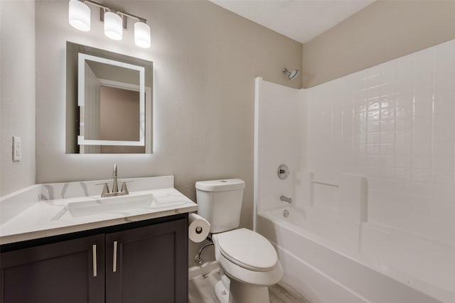 bathroom with shower / bathing tub combination, vanity, and toilet