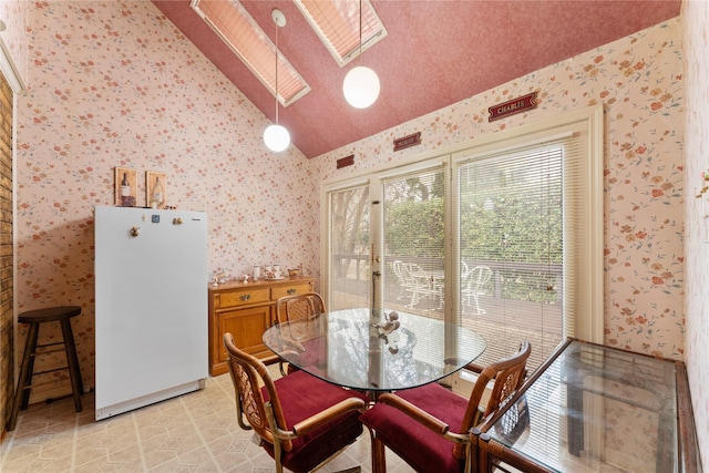 dining room with lofted ceiling with skylight