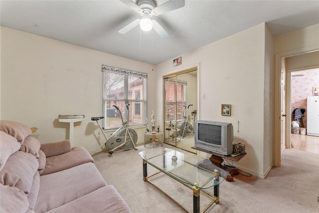 living room with ceiling fan and light colored carpet