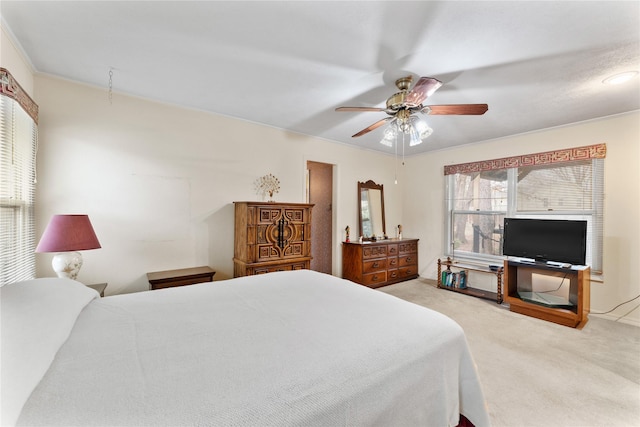 bedroom featuring ceiling fan and light carpet