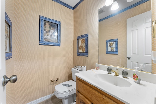 bathroom featuring vanity, crown molding, and toilet