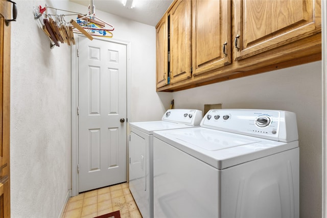 laundry area featuring cabinets and separate washer and dryer