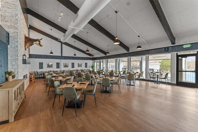 dining room with high vaulted ceiling, beam ceiling, and hardwood / wood-style floors