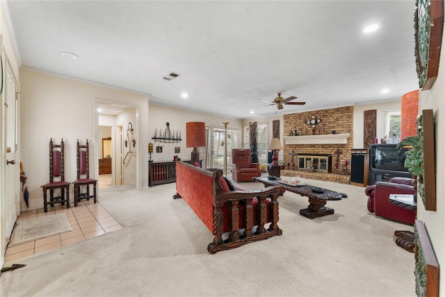 living room with ornamental molding, a brick fireplace, a healthy amount of sunlight, and light carpet