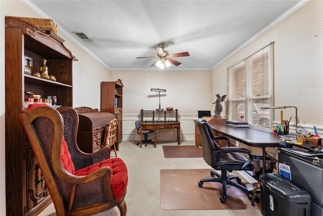 carpeted office with crown molding, a textured ceiling, and ceiling fan