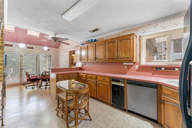 kitchen featuring a textured ceiling, stainless steel dishwasher, kitchen peninsula, and ceiling fan