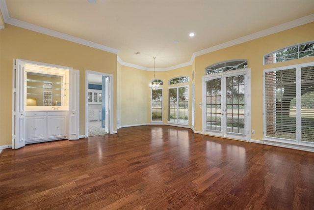 interior space with hardwood / wood-style floors, sink, a chandelier, crown molding, and french doors