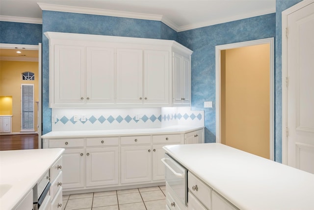 kitchen featuring white cabinetry, light tile patterned floors, backsplash, and crown molding