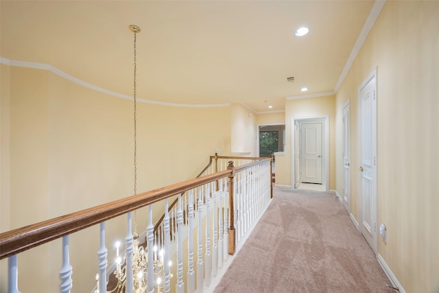 hall with light colored carpet and ornamental molding