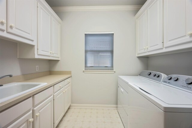 washroom with sink, cabinets, crown molding, and independent washer and dryer