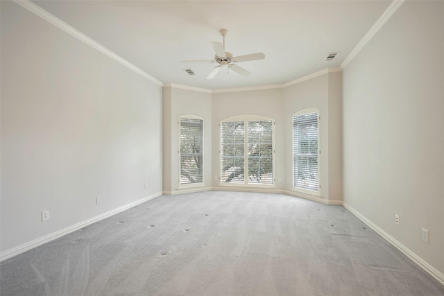 carpeted spare room featuring ornamental molding and ceiling fan