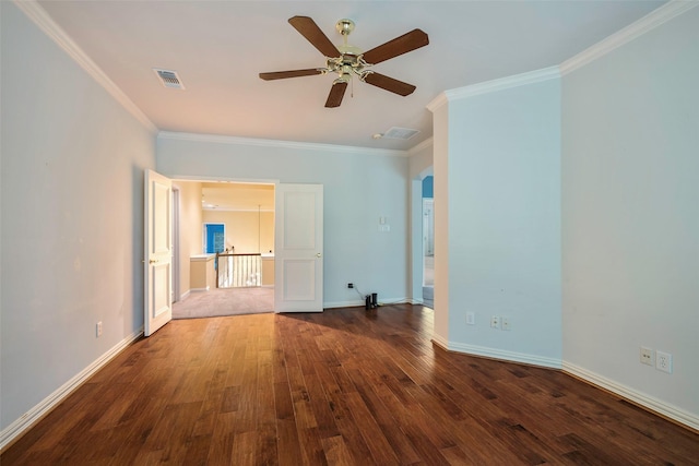 empty room featuring ornamental molding, dark wood-type flooring, and ceiling fan