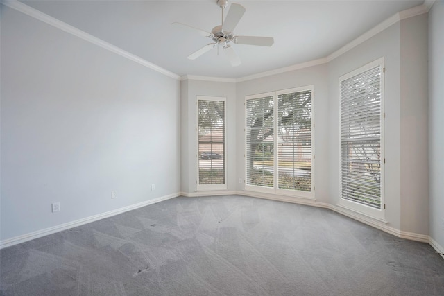 empty room featuring crown molding, carpet floors, and ceiling fan