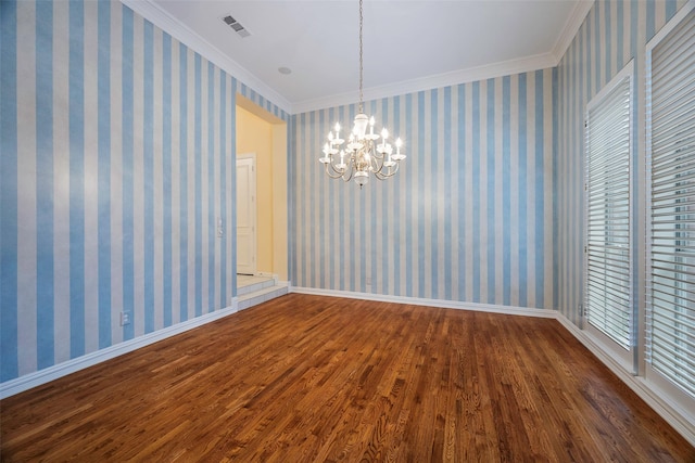 unfurnished room with ornamental molding, dark hardwood / wood-style floors, and an inviting chandelier