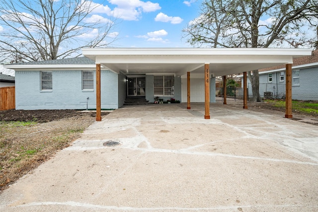 view of parking featuring a garage and a carport