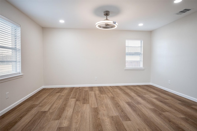 unfurnished room featuring hardwood / wood-style flooring