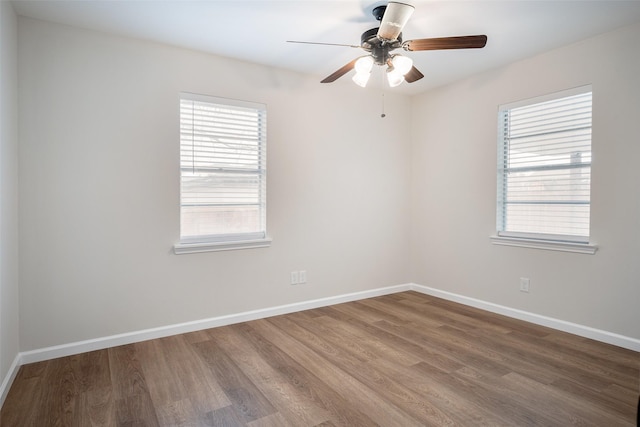 unfurnished room featuring hardwood / wood-style flooring, a healthy amount of sunlight, and ceiling fan