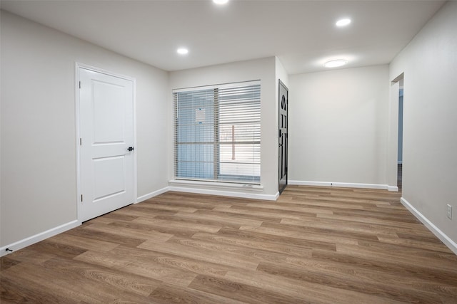 empty room with light hardwood / wood-style floors