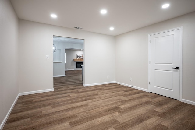 unfurnished room with dark hardwood / wood-style floors