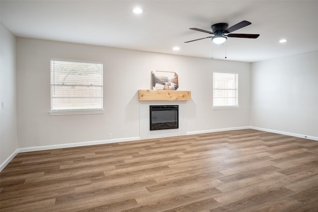 unfurnished living room featuring hardwood / wood-style floors and ceiling fan