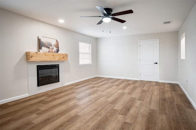 unfurnished living room with hardwood / wood-style floors and ceiling fan