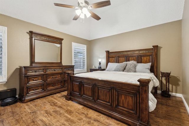 bedroom with lofted ceiling, hardwood / wood-style flooring, and ceiling fan