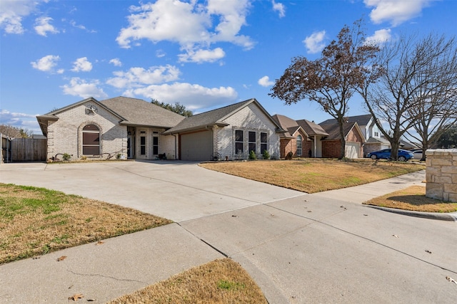 ranch-style house with a garage and a front yard