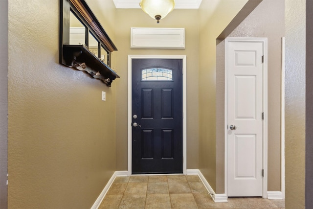 doorway featuring light tile patterned flooring and ornamental molding