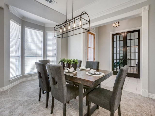 carpeted dining area featuring french doors and crown molding