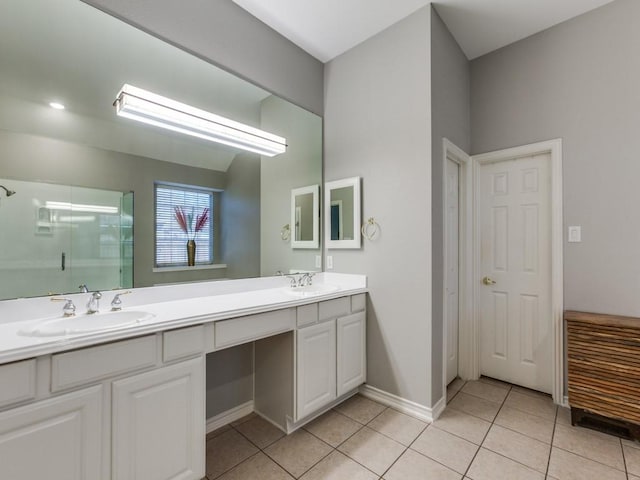 full bath featuring double vanity, tile patterned floors, a sink, and a shower stall