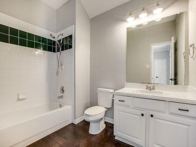 bathroom with baseboards, toilet, wood finished floors,  shower combination, and vanity