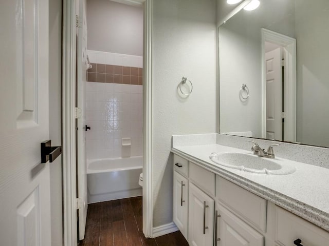 full bathroom featuring bathtub / shower combination, vanity, toilet, and wood finished floors