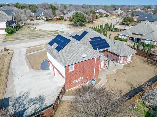 view of front of property with a front yard and solar panels