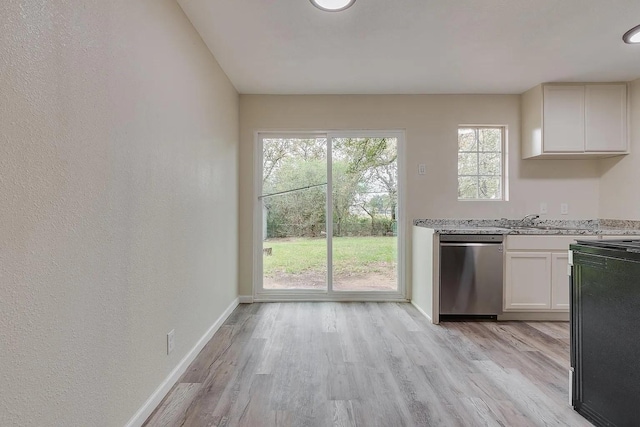 kitchen featuring a wealth of natural light, dishwasher, white cabinets, and light wood-type flooring