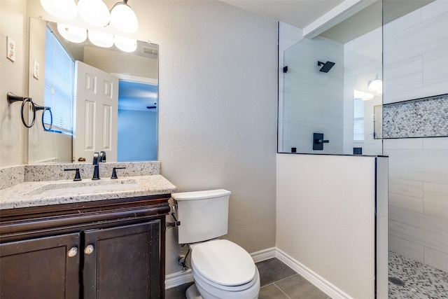 bathroom featuring a shower with door, vanity, tile patterned flooring, and toilet