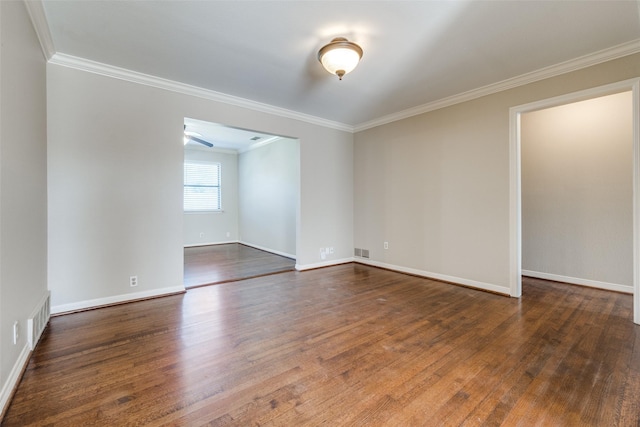 spare room with crown molding and dark wood-type flooring