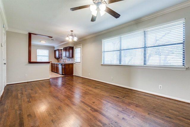 unfurnished living room featuring crown molding, ceiling fan with notable chandelier, and dark hardwood / wood-style floors