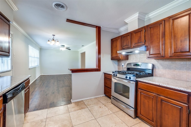 kitchen with crown molding, light tile patterned floors, ceiling fan, stainless steel appliances, and backsplash