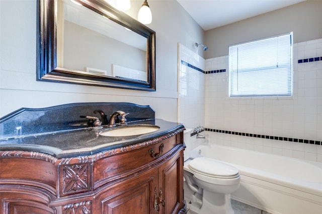 full bathroom with tiled shower / bath, vanity, and toilet