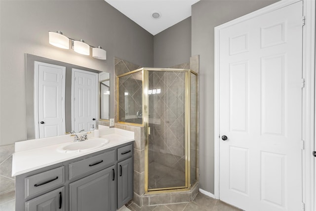 bathroom with vanity, tile patterned flooring, and walk in shower